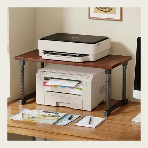Desk riser on a home-office desk with a printer on top and the lower level in use