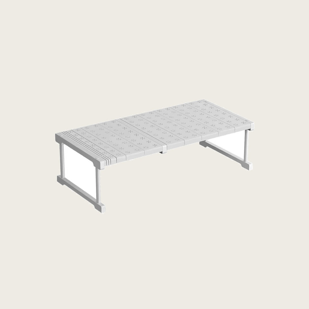 Expandable carbon steel shelf riser on a light rice background
