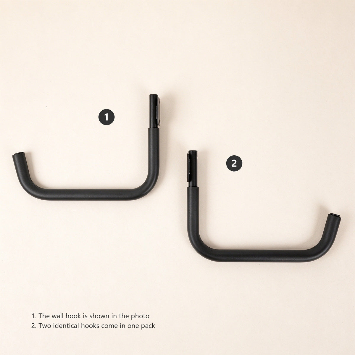 Two identical black kayak wall hooks laid flat with a numbered two-item parts list